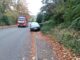 Lorry passing a car which is blocking the pavement
