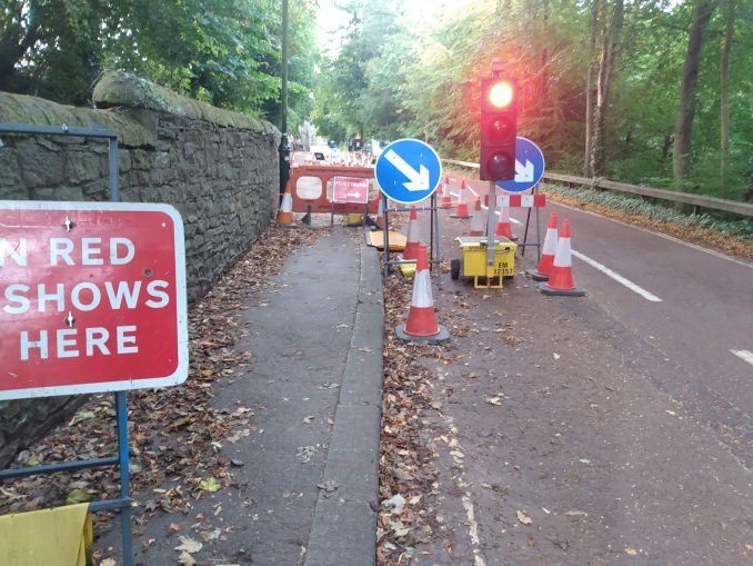 A temporary traffic light controlling traffic adjacent to Durham School cricket field.